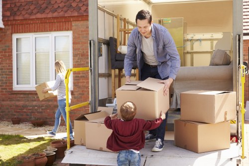 Movers handling furniture with a London man van