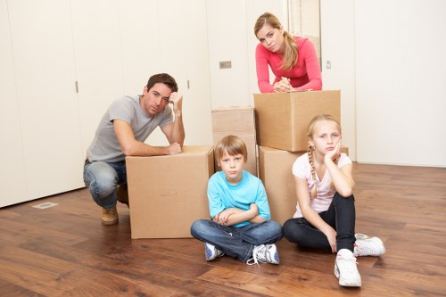 Professional mover handling furniture with a van in London