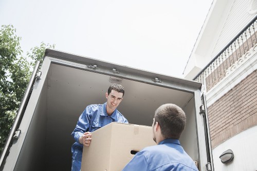 Volunteers loading donated furniture into a van for charity