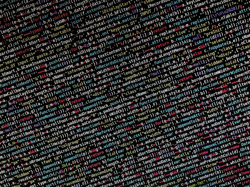 Close-up view of a computer screen displaying lines of programming code in a text editor, with syntax highlighting in green, blue, and pink. The code includes variables related to database validation,